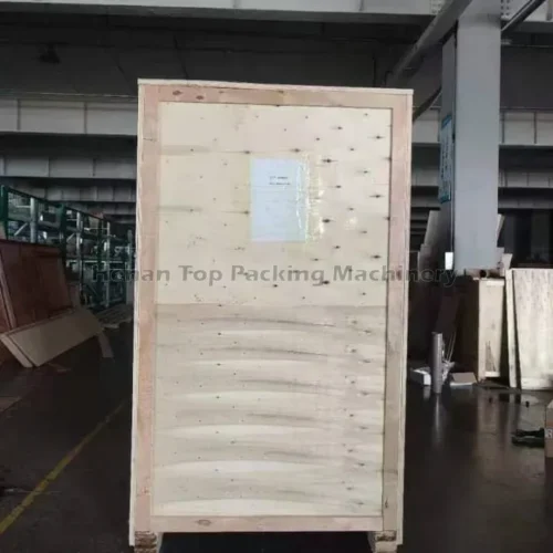 Machine d'emballage de sachets de poudre dans des caisses en bois